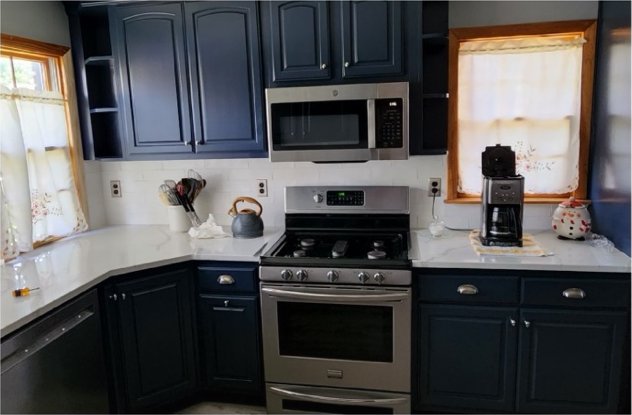 Finished navy kitchen at the range wall