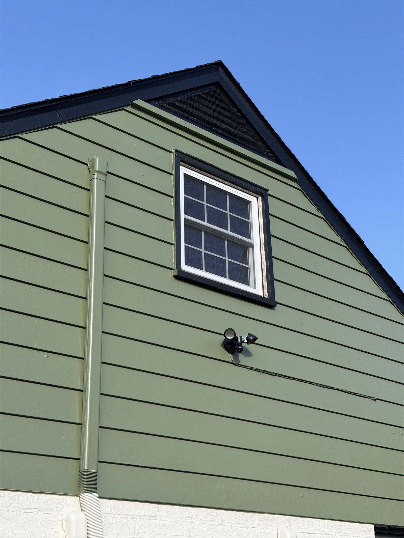 Green siding exterior with gable