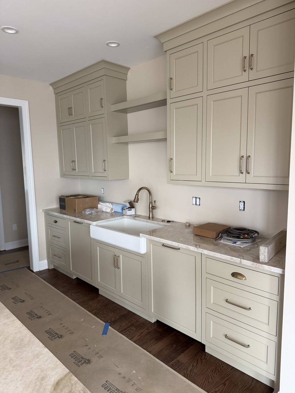 Cream kitchen sink run with stone wall
