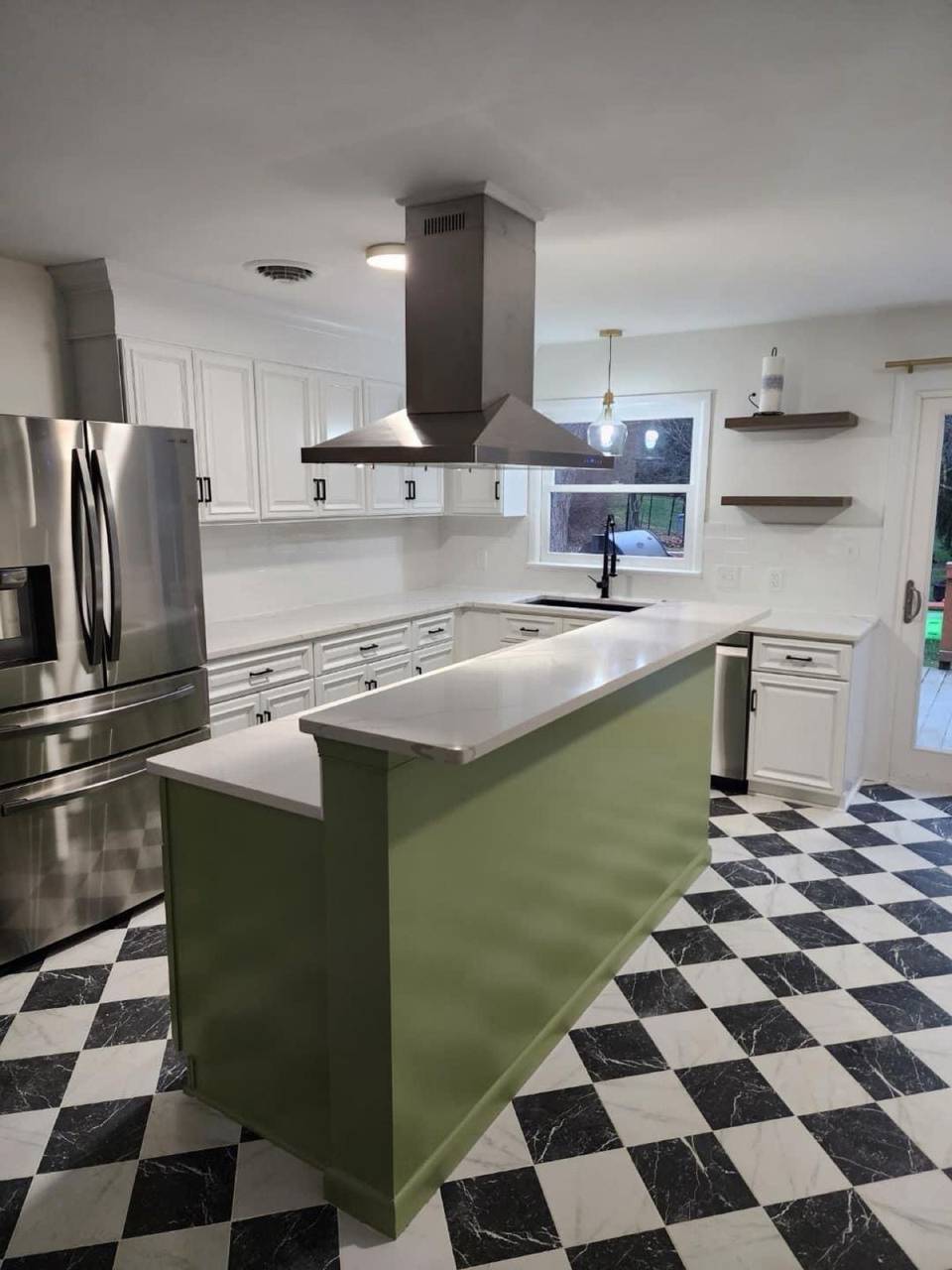 Remodeled kitchen with white cabinets, green island and checkerboard floor